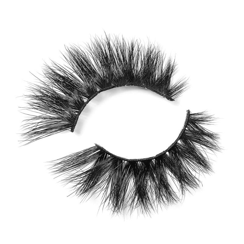 On a white background, beautiful two black eye lashes called Betty Luxury Mink Lashes in a flare shape. 18mm length. medium volume. Material : Mink. Bold Effect.