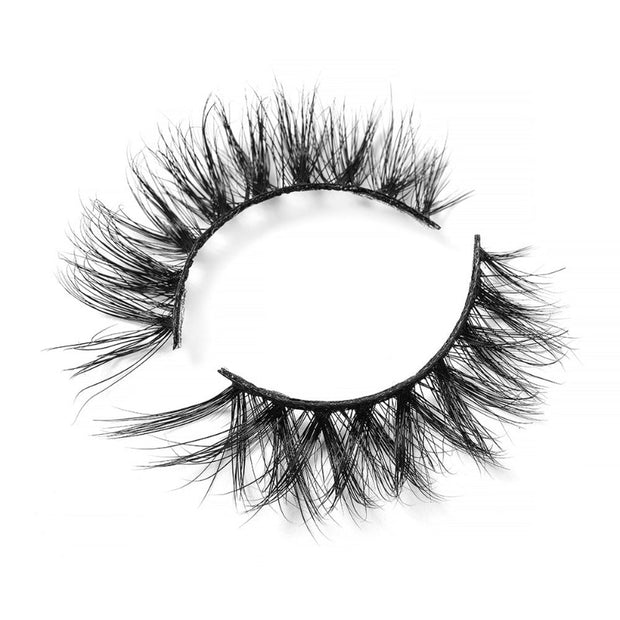 On a white background, beautiful two black eye lashes called Chicago Luxury Mink Lashes in a flare shape. 15mm length. maximum volume. Material : 3d Mink. Bold, Full-body Effect.