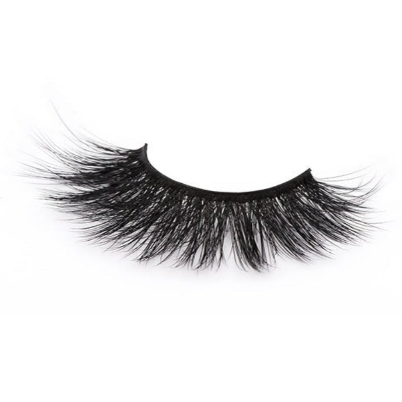 On a white background, beautiful black eye lashes called Cassandra Faux Mink Lashes in a round shape. 20mm length. natural volume. Material : Silk