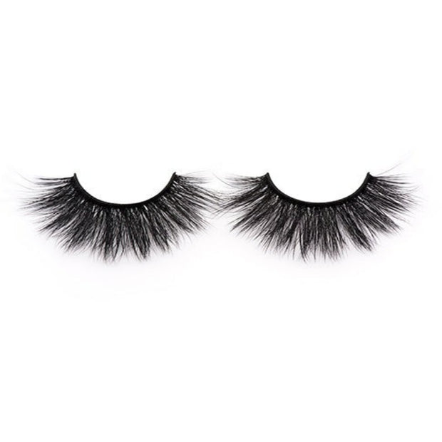 On a white background, beautiful two black eye lashes called Cassandra Faux Mink Lashes in a round shape. 20mm length. natural volume. Material : Silk